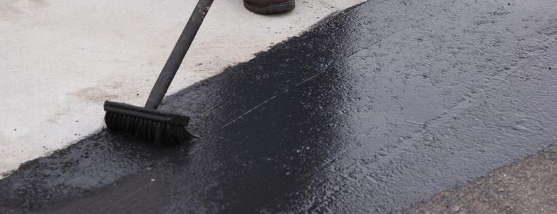Asphalt sealcoating and crack sealing